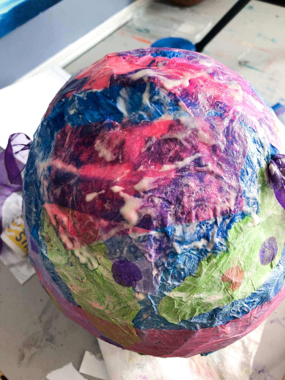 pink, purple and green wet tissue paper with flour mixture on it.