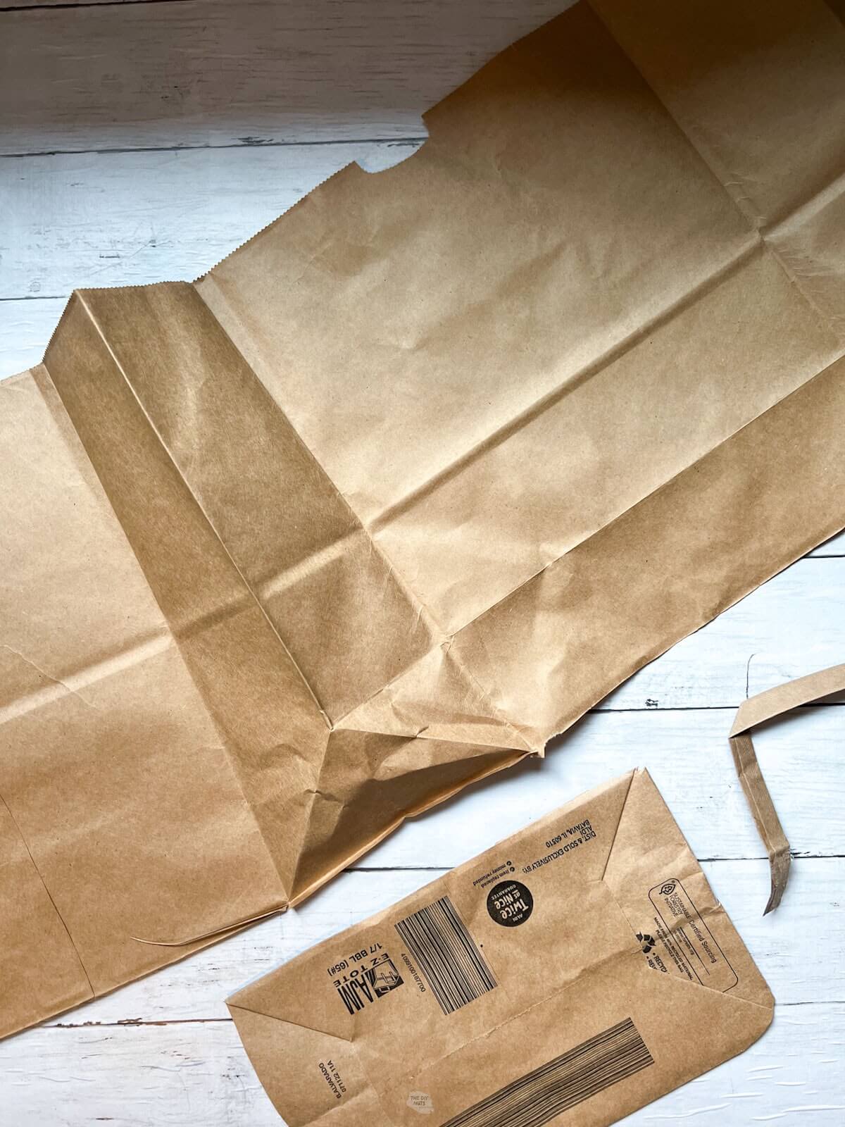 brown paper bag opened up with parts cut off.