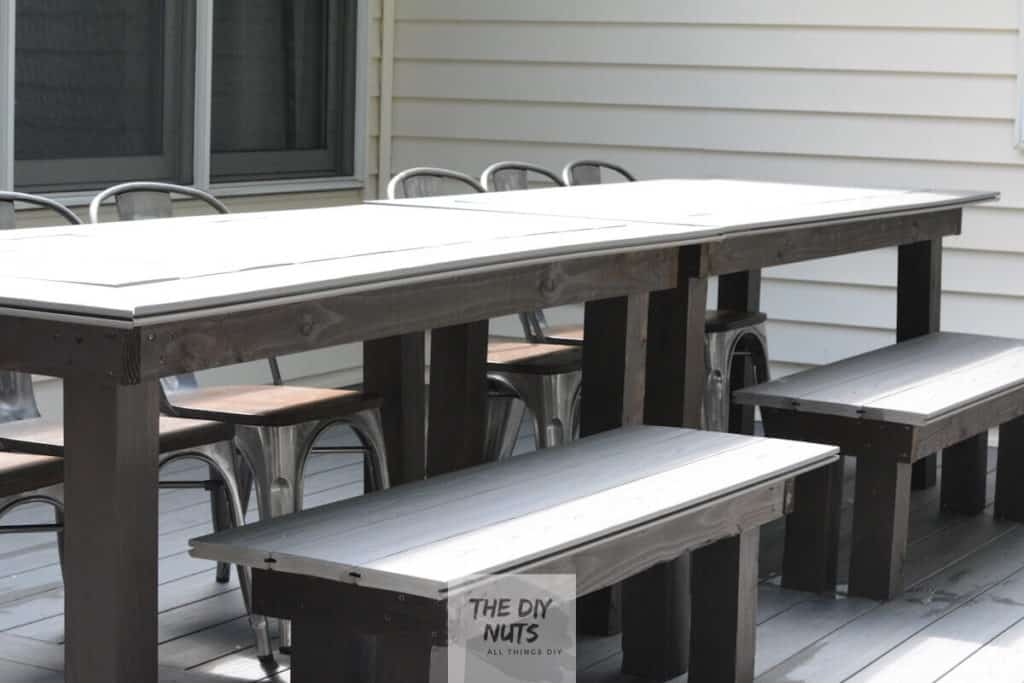 Gray DIY outdoor dining table and composite benches made with leftover composite decking.
