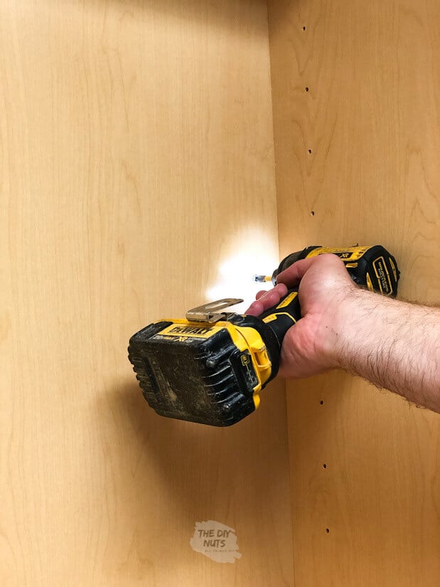 Attaching laundry room cabinets with drill