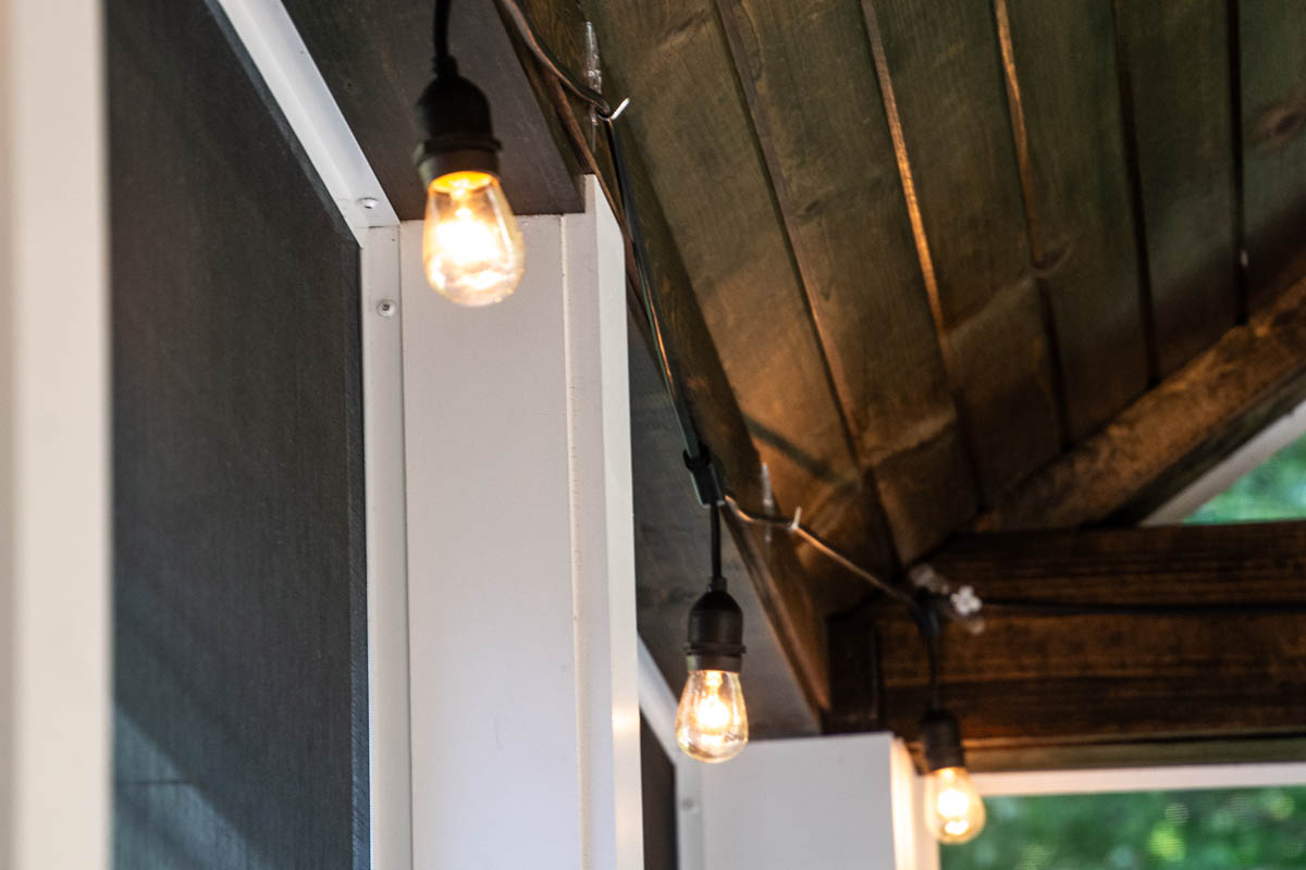 string lights in porch with wood ceiling.