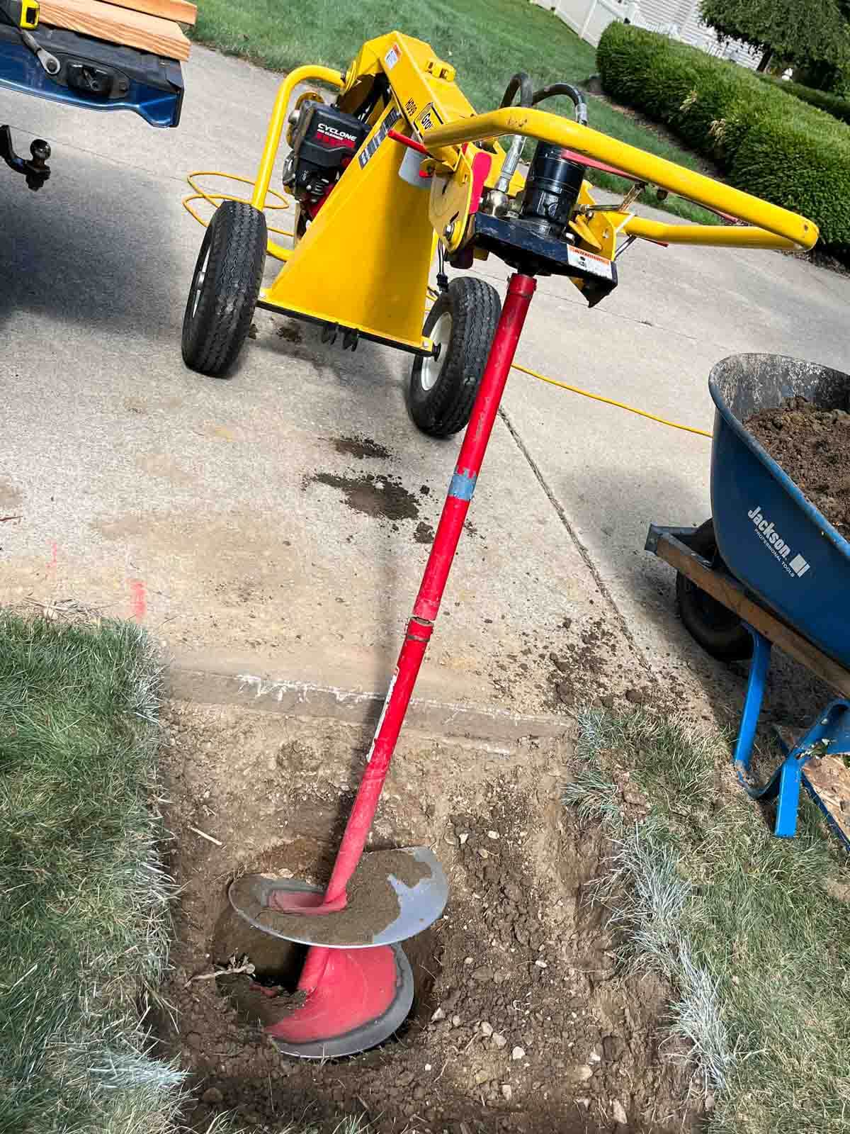 towable auger digging hole for basketball hoop.
