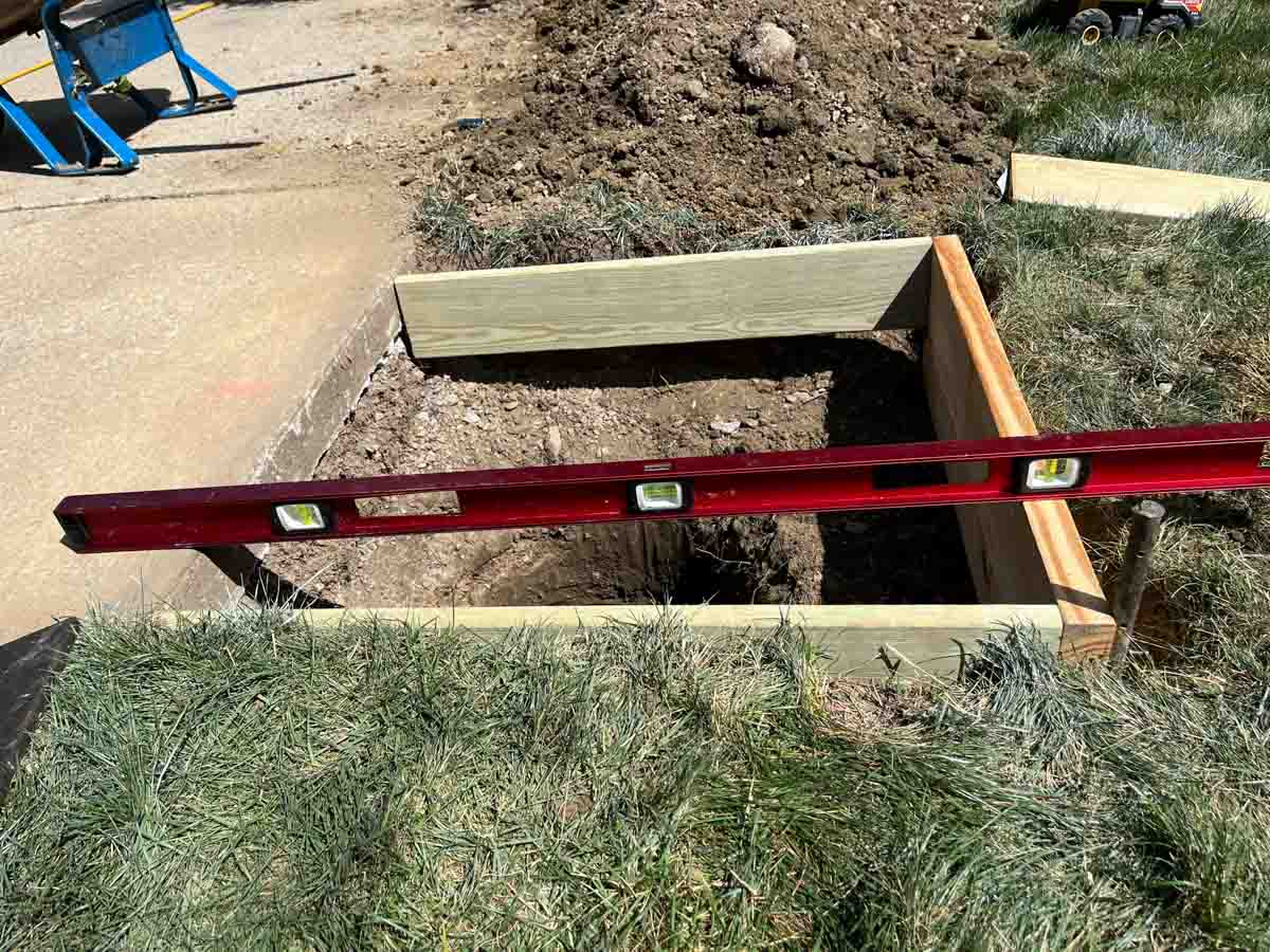 4 foot level on wood frame in ground next to driveway.