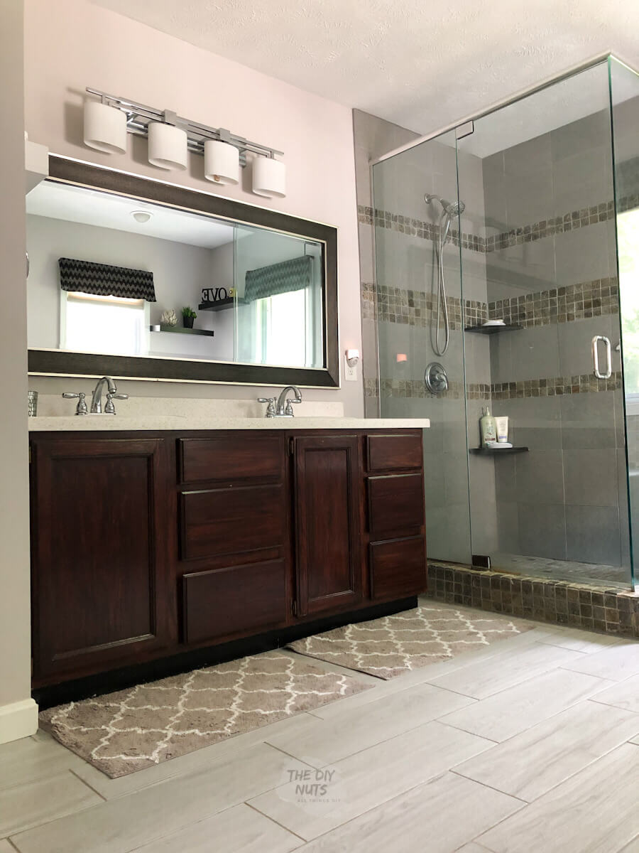 lights off in main bath room with gray tile, dark walnut vanity and grayish walls