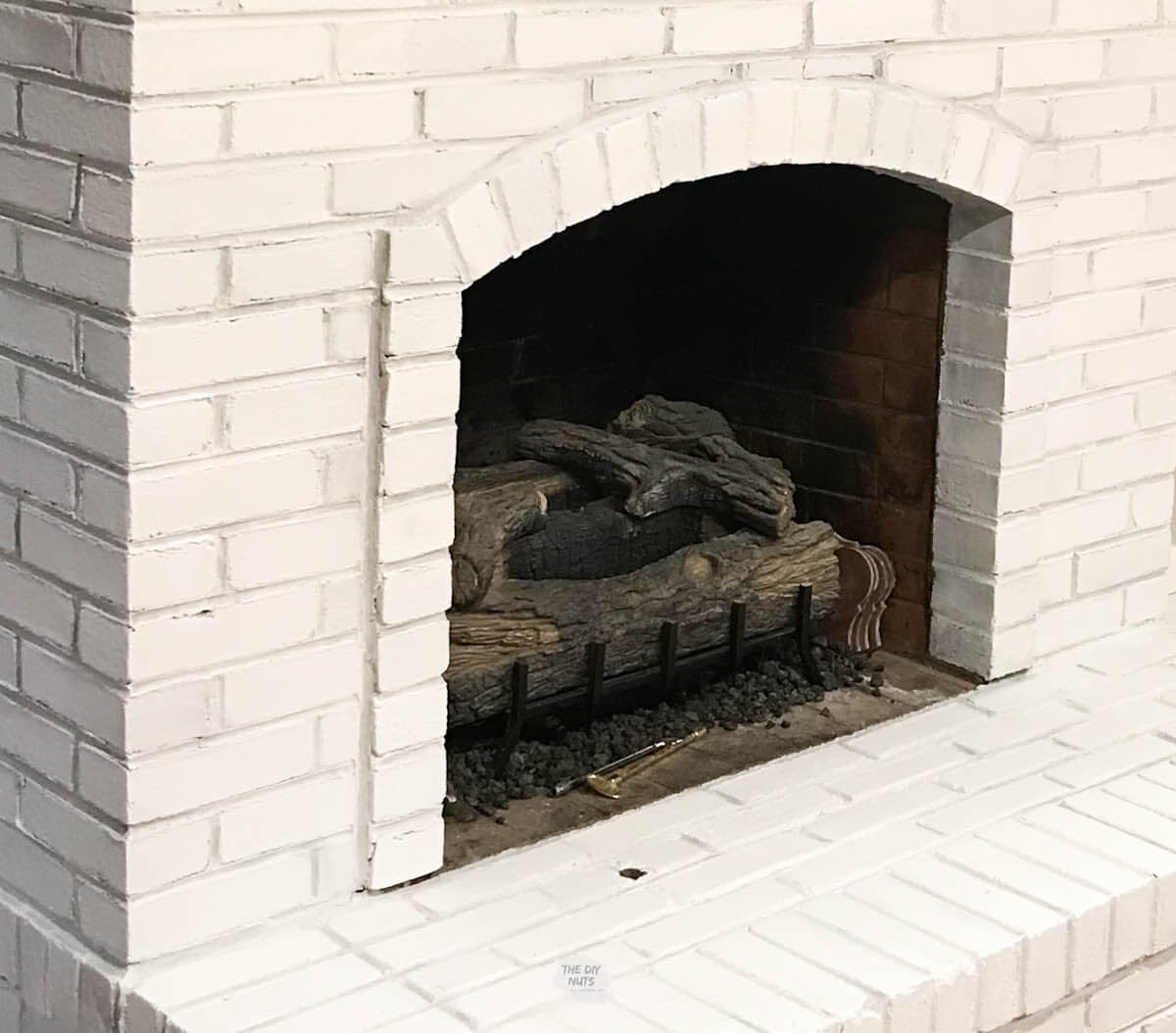white painted brick fireplace.