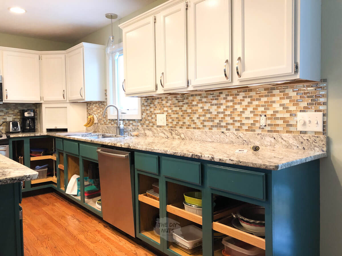 green painted kitchen cabinets with white upper cabinets and glass mosaic tile before painting