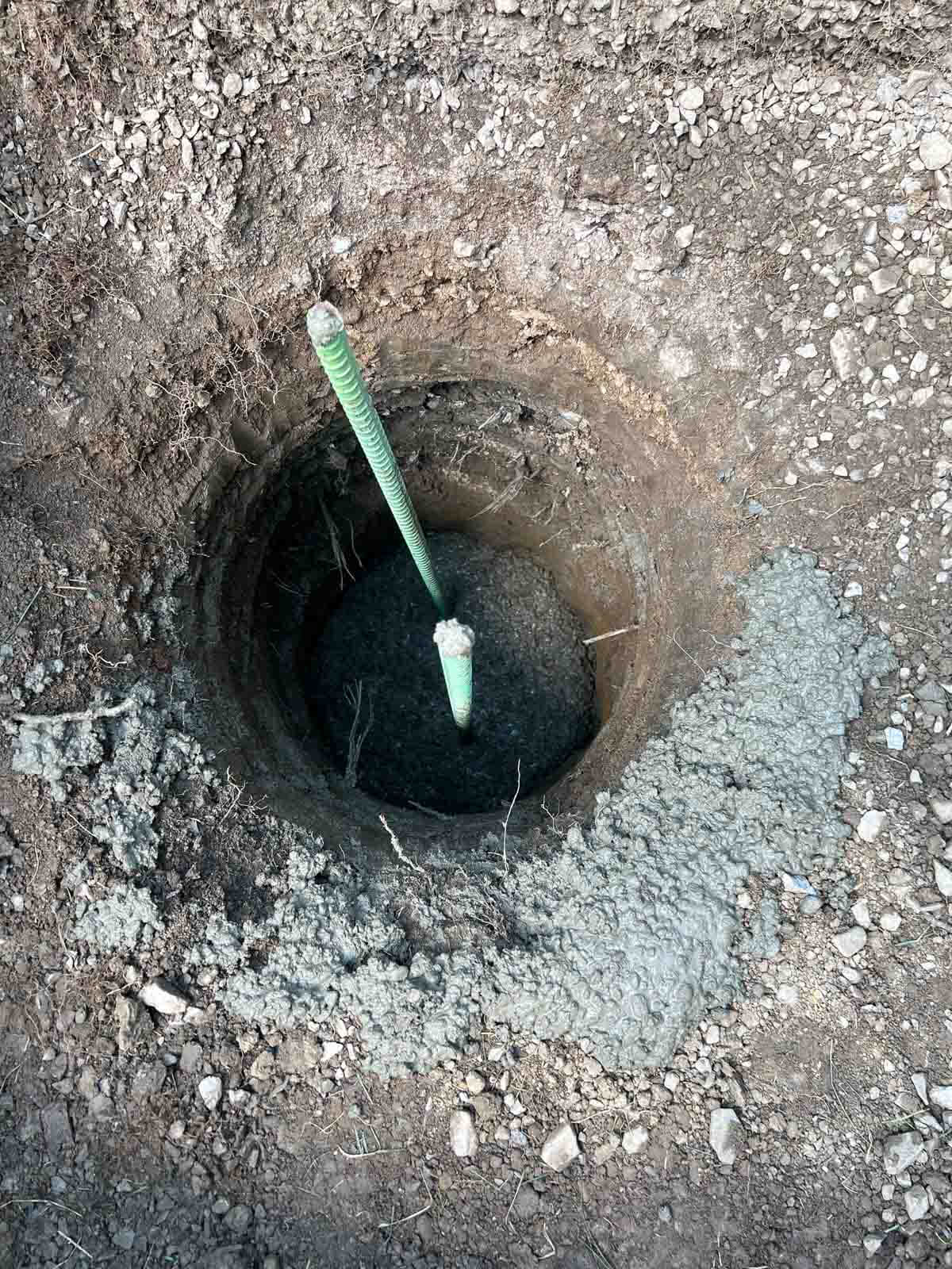 hole in ground with rebarb sticking out.