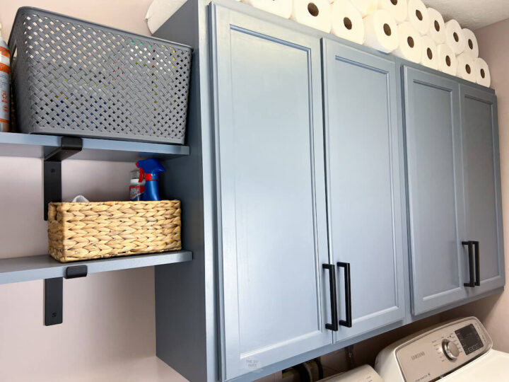 Blue Gray Laundry room shelves with wall cabinets.