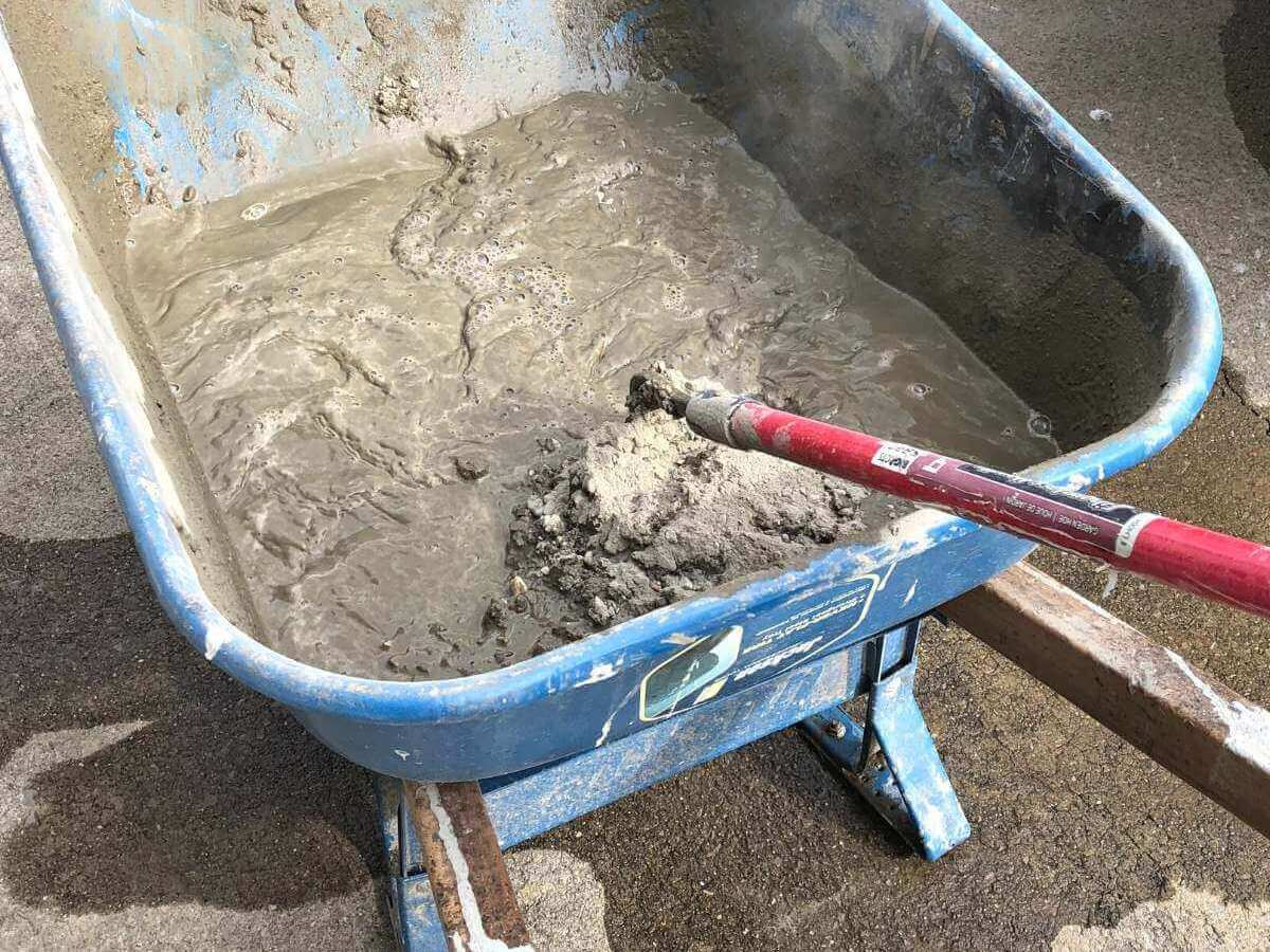 concrete in wheelbarrow after being mixed together.