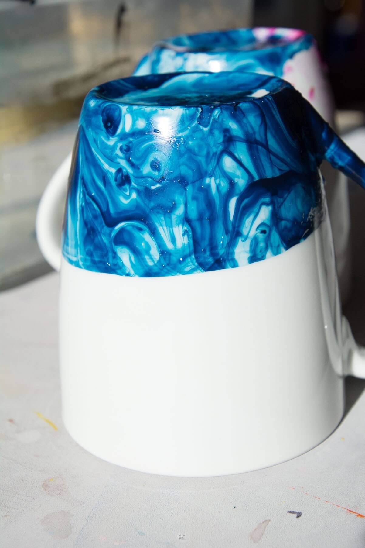 blue marbled ceramic mug flipped over.