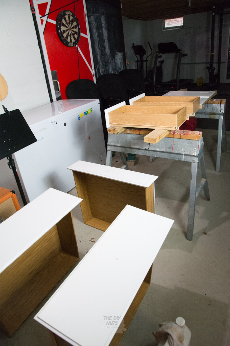Sawhorses and white painted kitchen cabinet doors and drawers