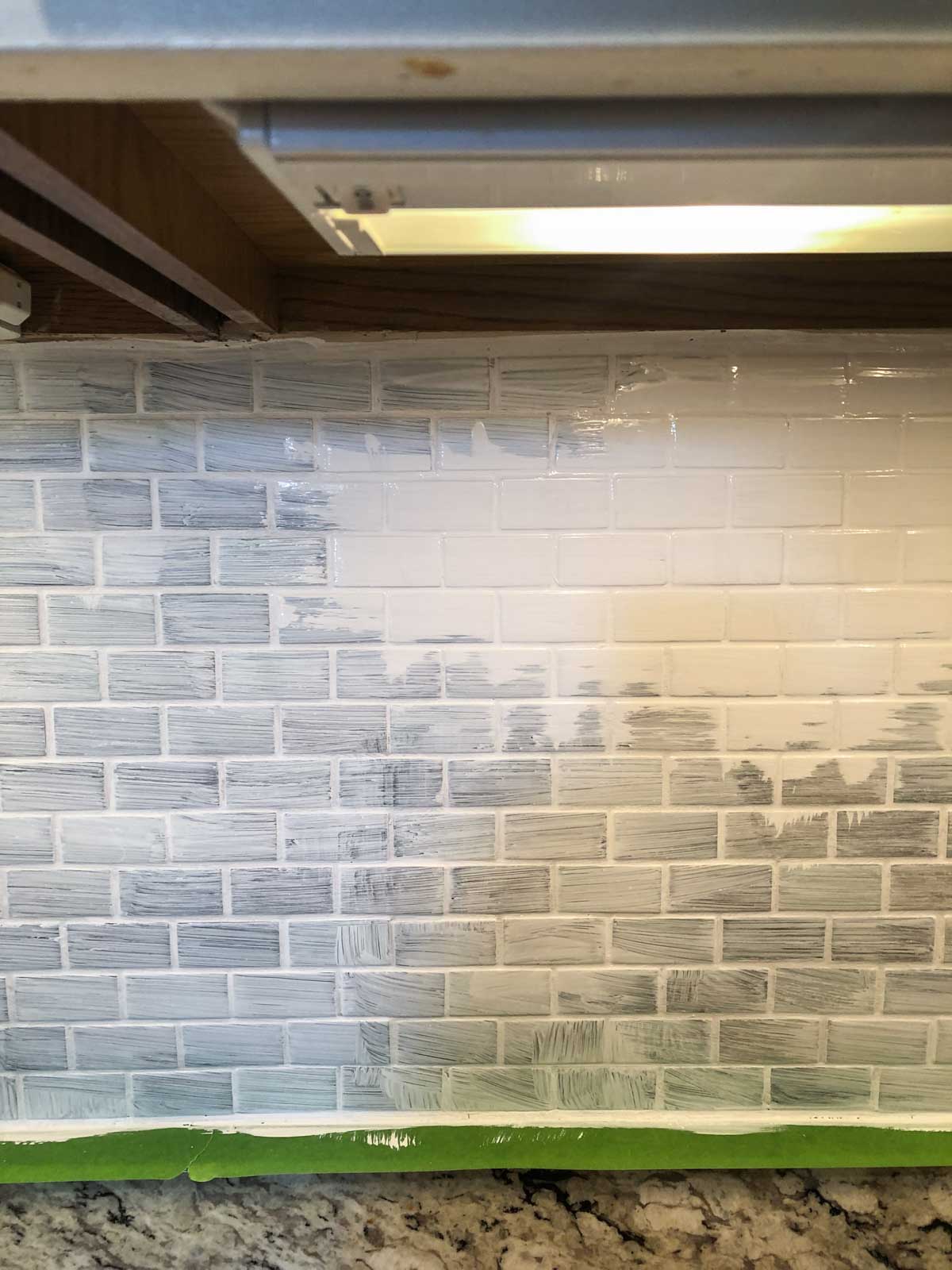 white paint on primed glass backsplash in kitchen.