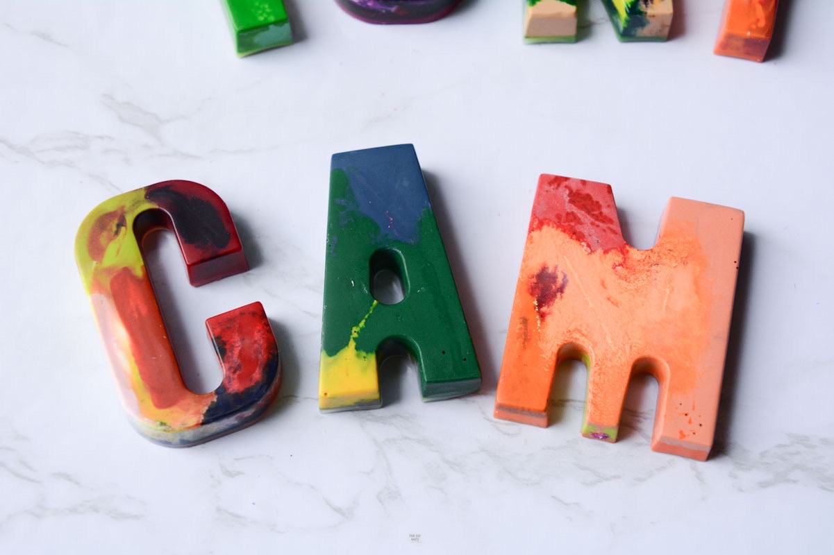 cam spelled in rainbow letter crayons.