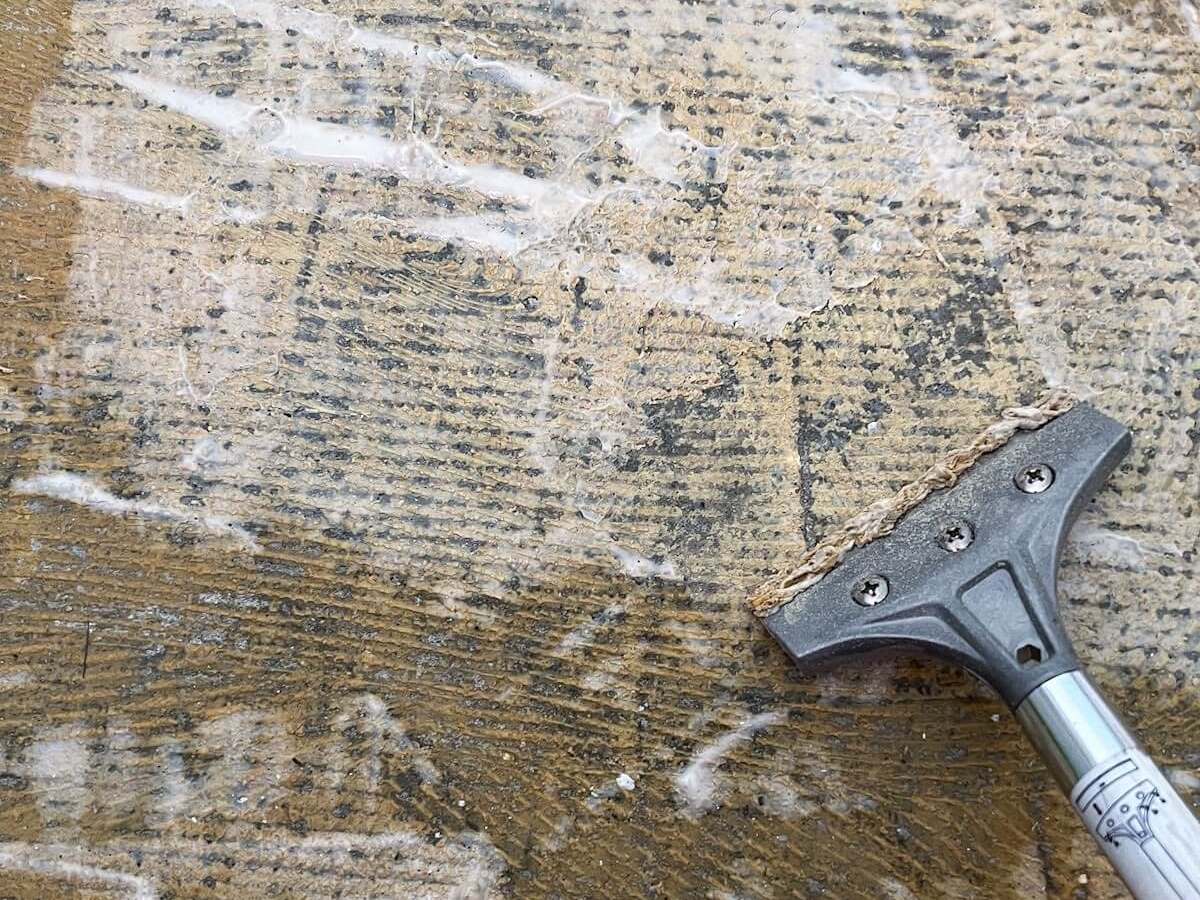 silver floor scraper trying to get carpet glue off concrete.