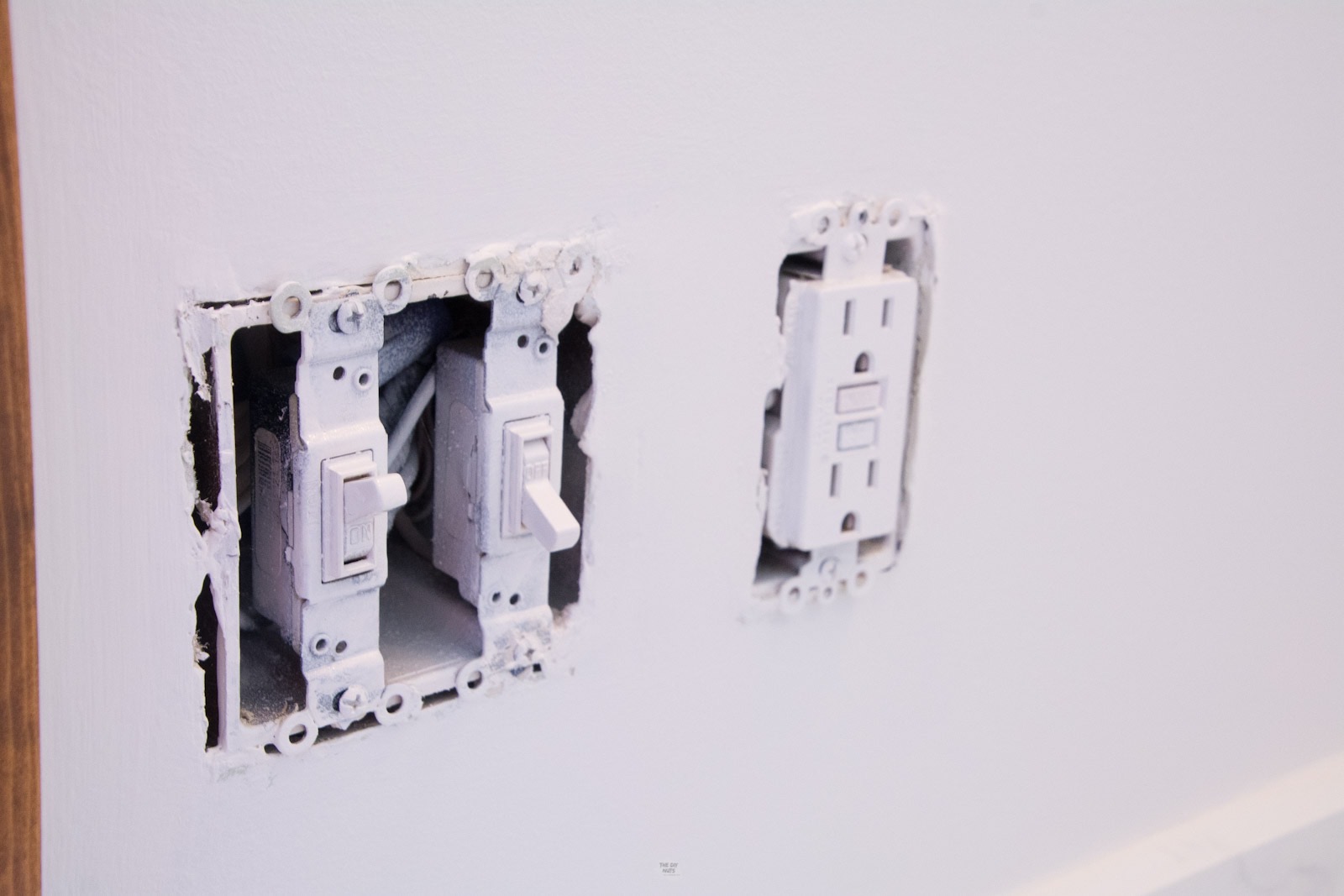 two light switches with outlets sprayed with white paint.