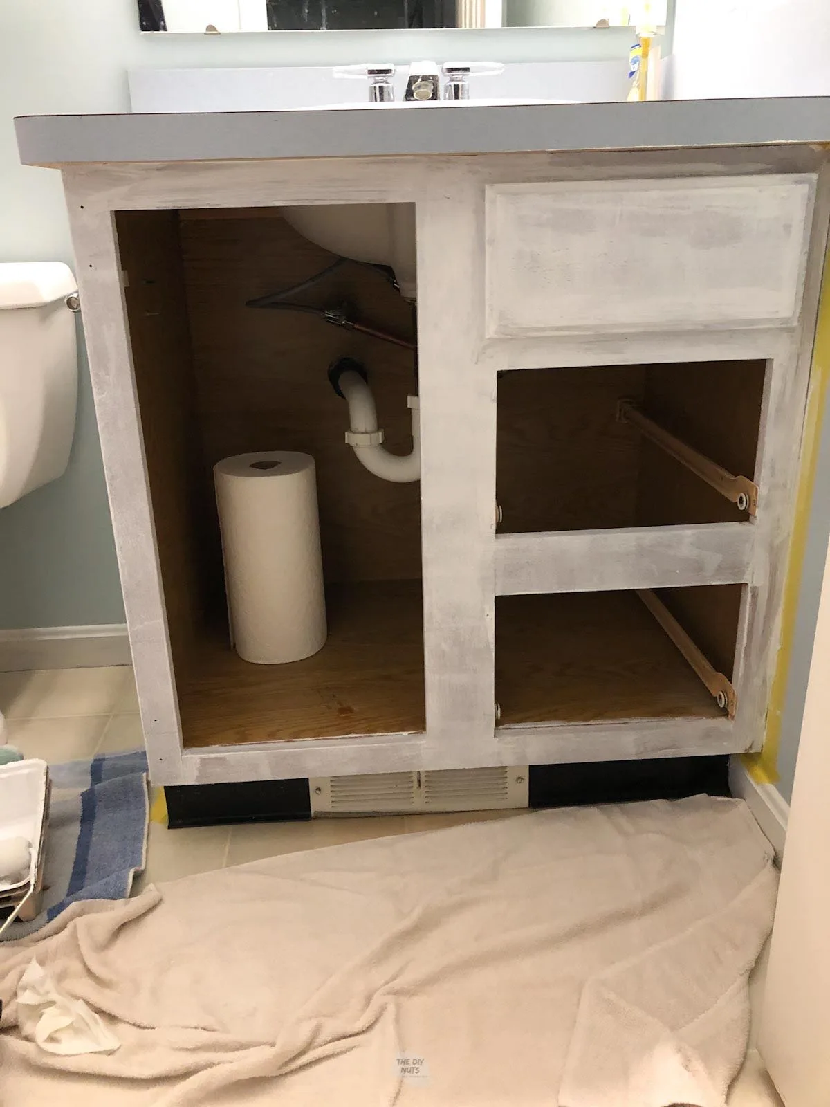 white primer on oak bathroom cabinet vanity.