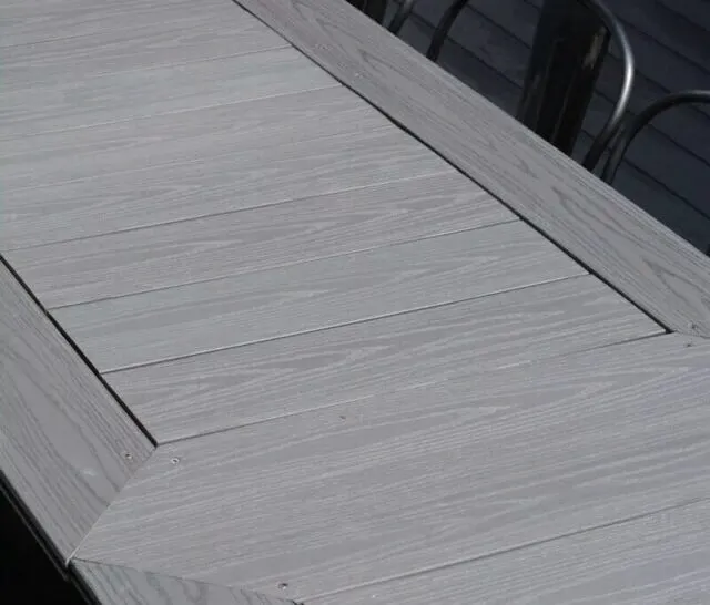 Gray composite decking top of a DIY outdoor dining table