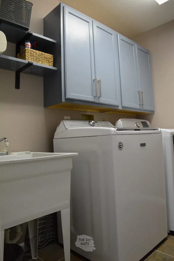 DIY laundry room wall cabinet idea from painted stock cabinets