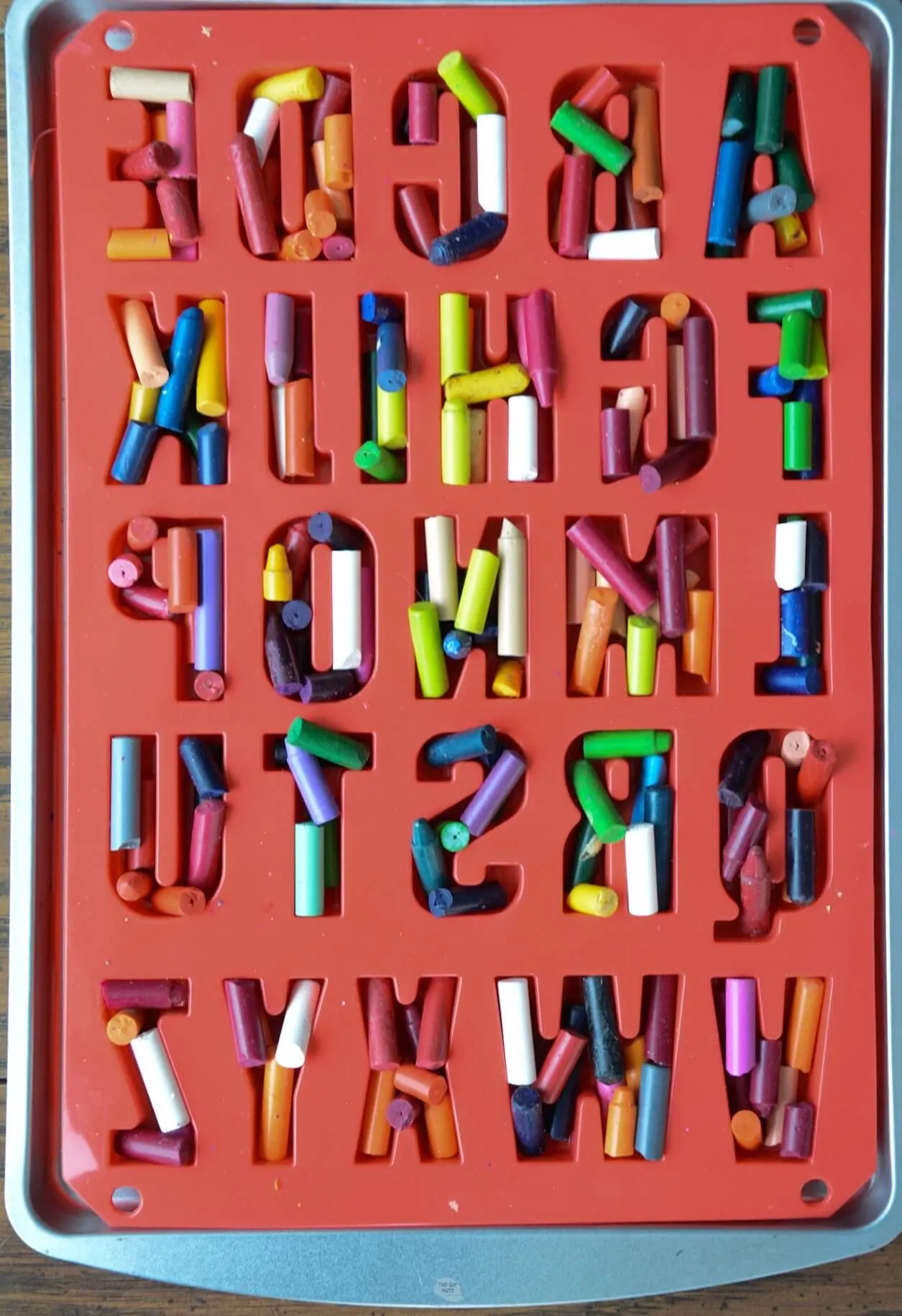 red letter molds filled with broken crayons.