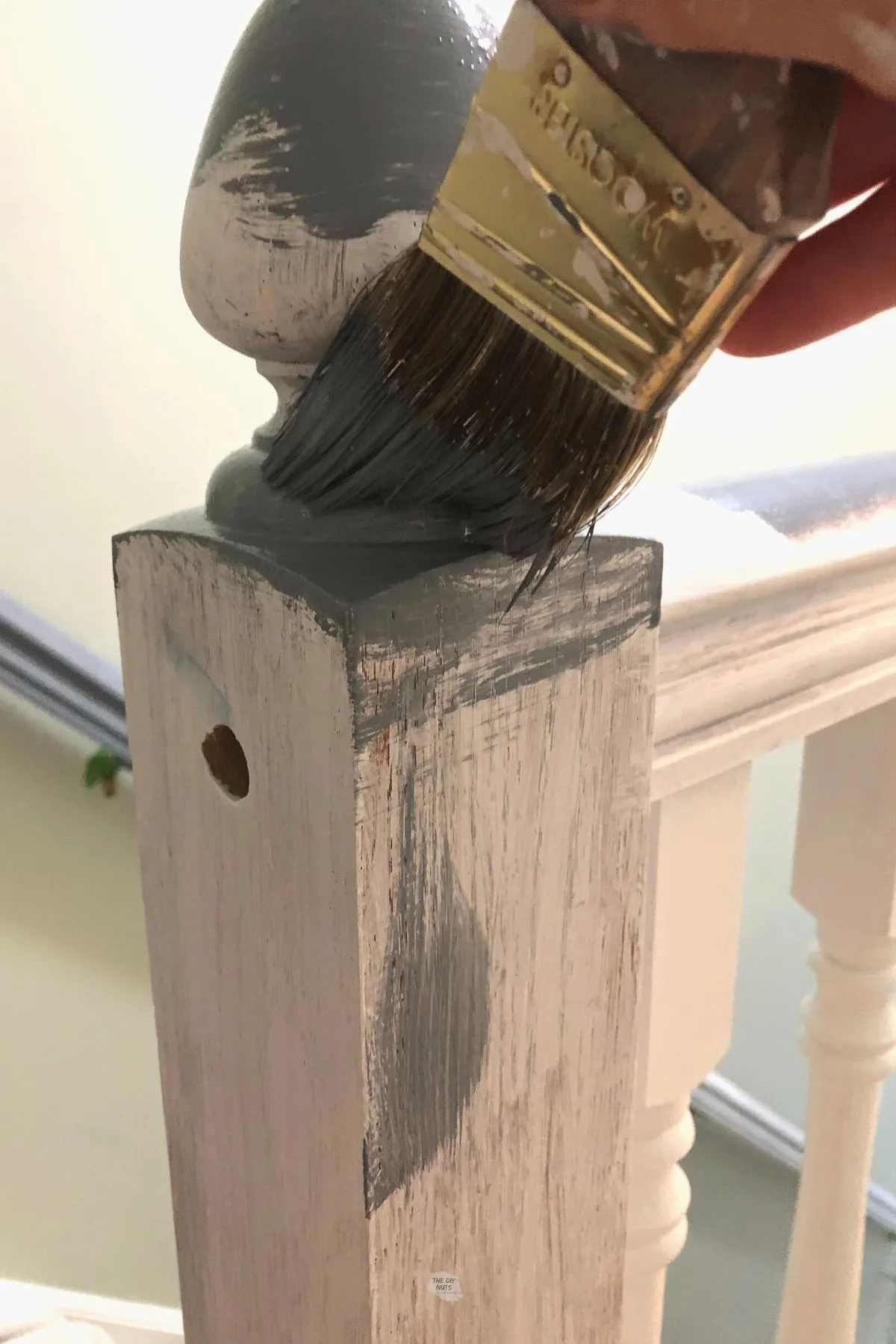paint brush adding color to handrail.