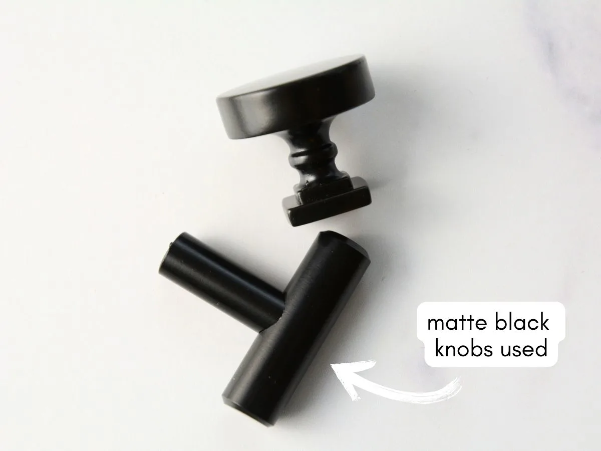 two matte black hardware knobs on white table with text overlay matte black knobs used.