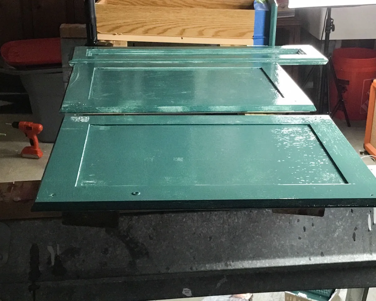 green paint drying on back of cabinet doors.