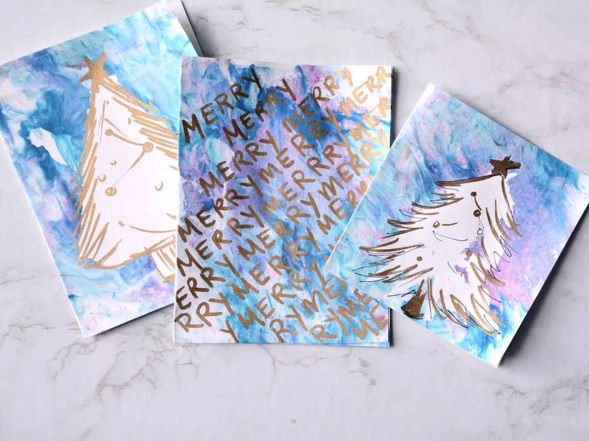 3 different Christmas cards made with shaving cream and paint.