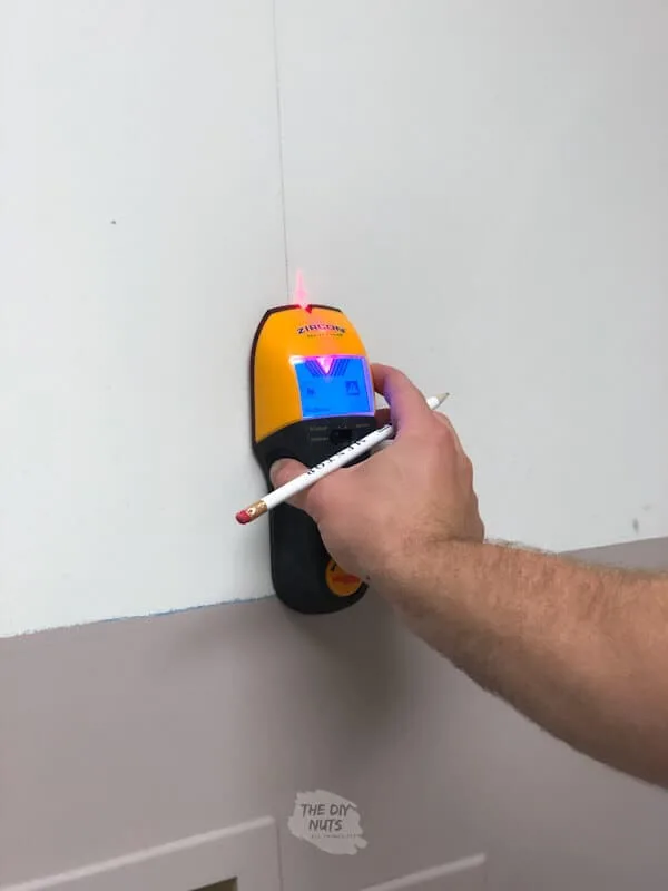 Stud finder used for laundry cabinet installation