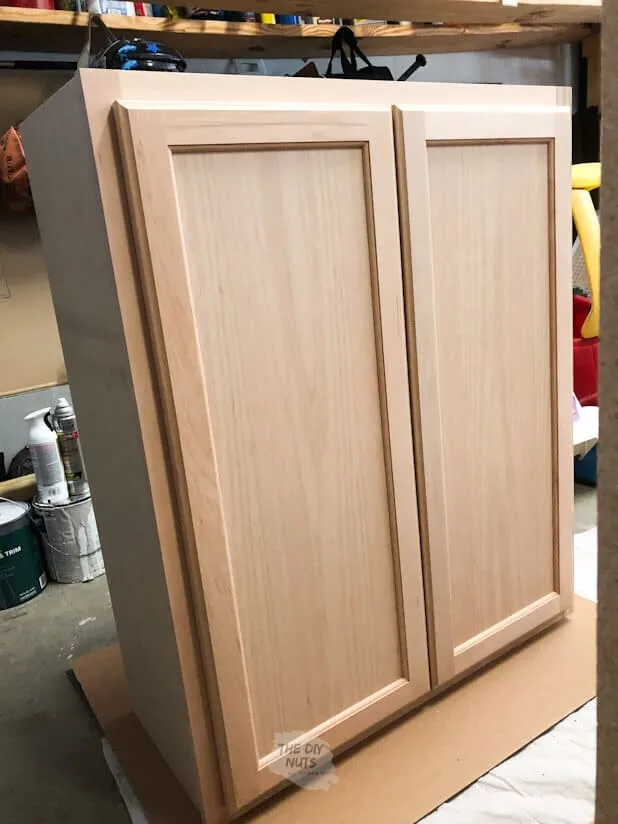 Wooden Hampton Bay Upper Stock Cabinets as DIY Laundry Room Storage.