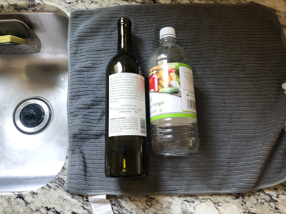 vinegar laying next to wine bottle to use for easy sticker removal